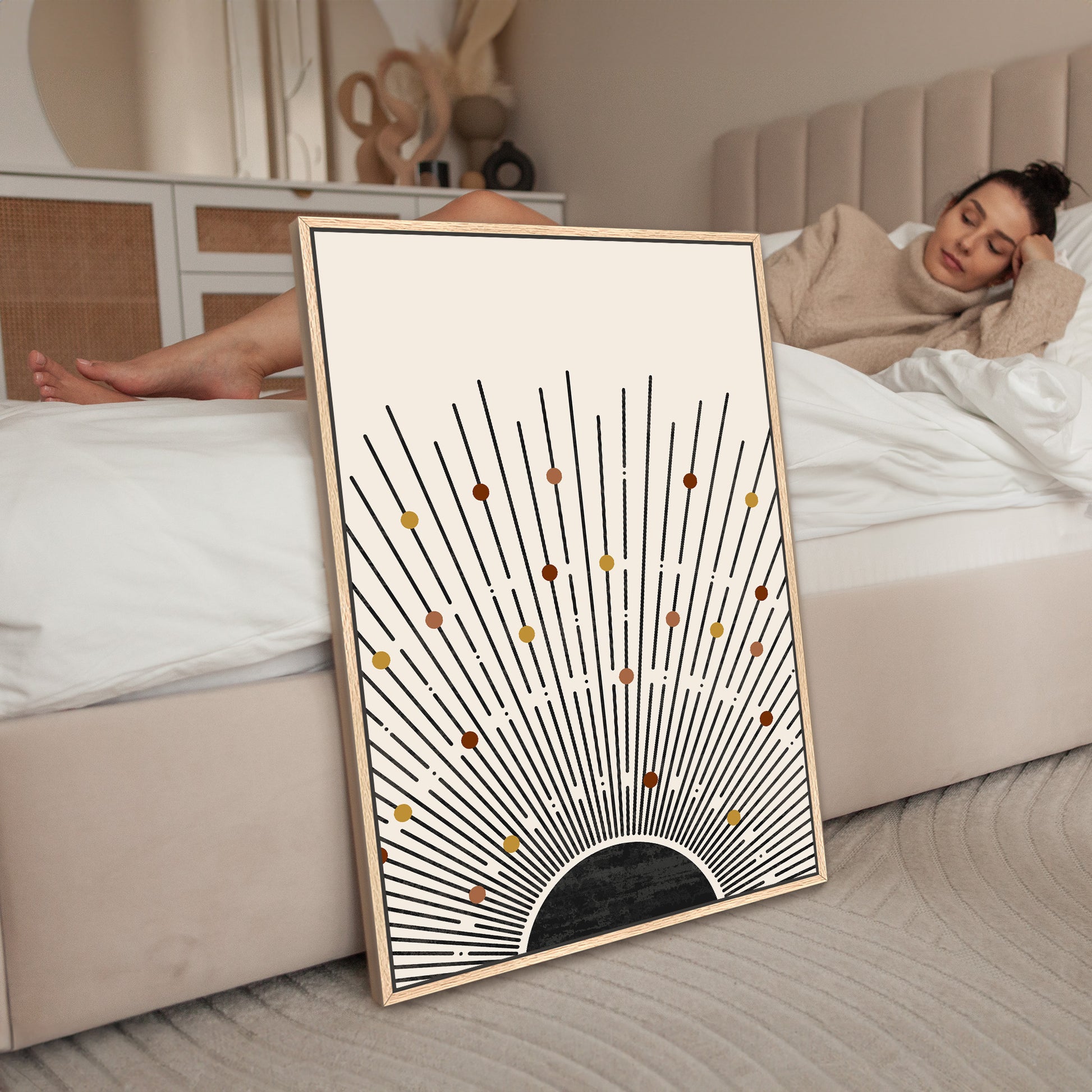 a woman laying on a bed next to a picture frame