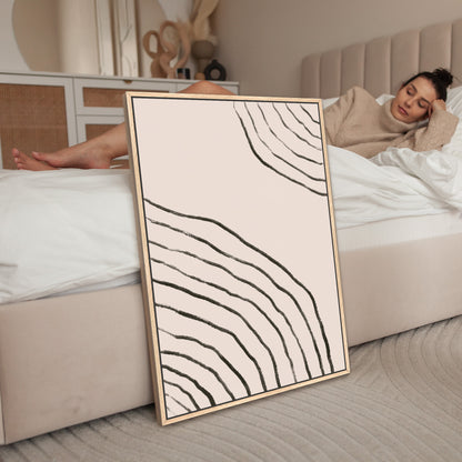 a woman laying on a bed next to a picture frame