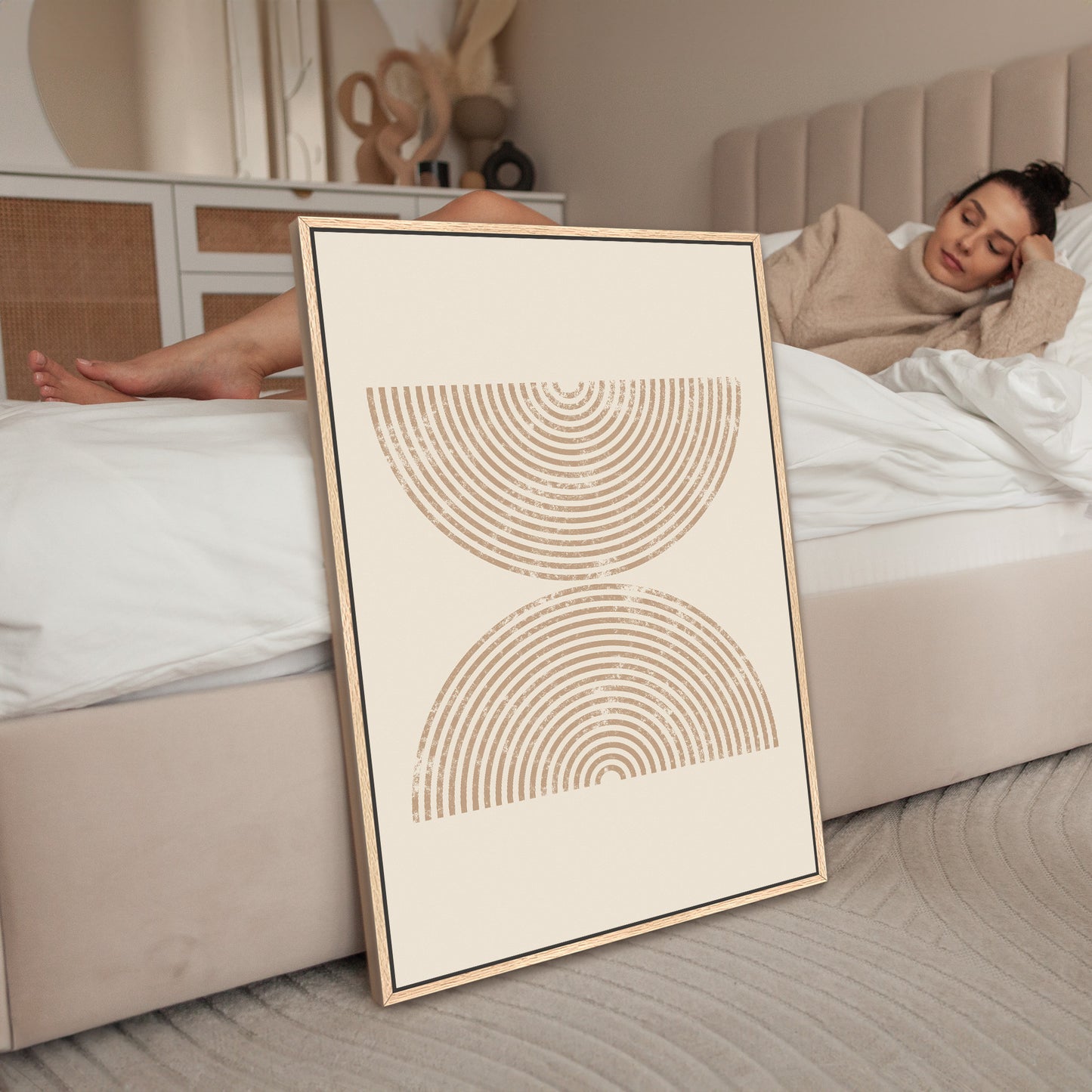 a woman laying on a bed next to a poster