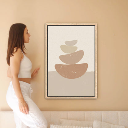 a woman standing in front of a picture of a stack of rocks