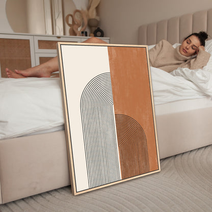 a woman laying on a bed next to a picture