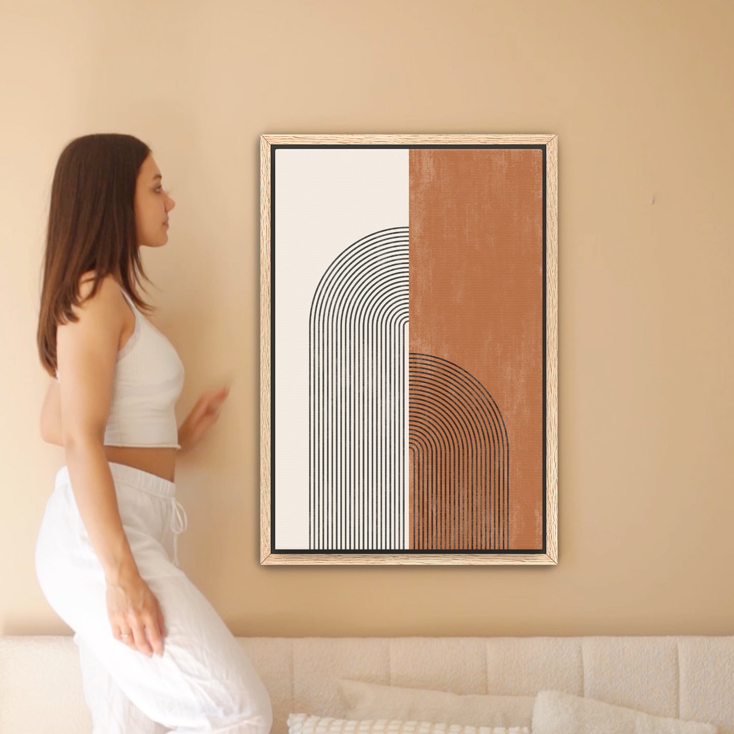 a woman standing in front of a painting on a wall