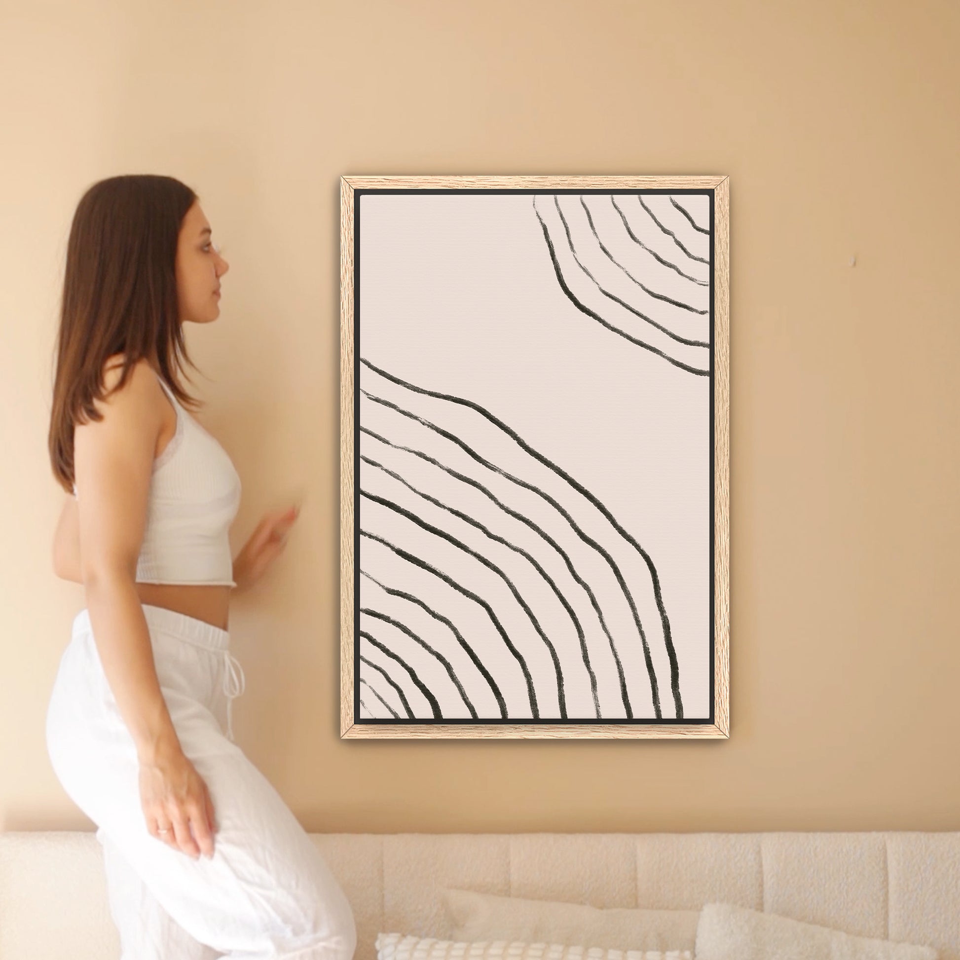 a woman standing in front of a painting on a wall