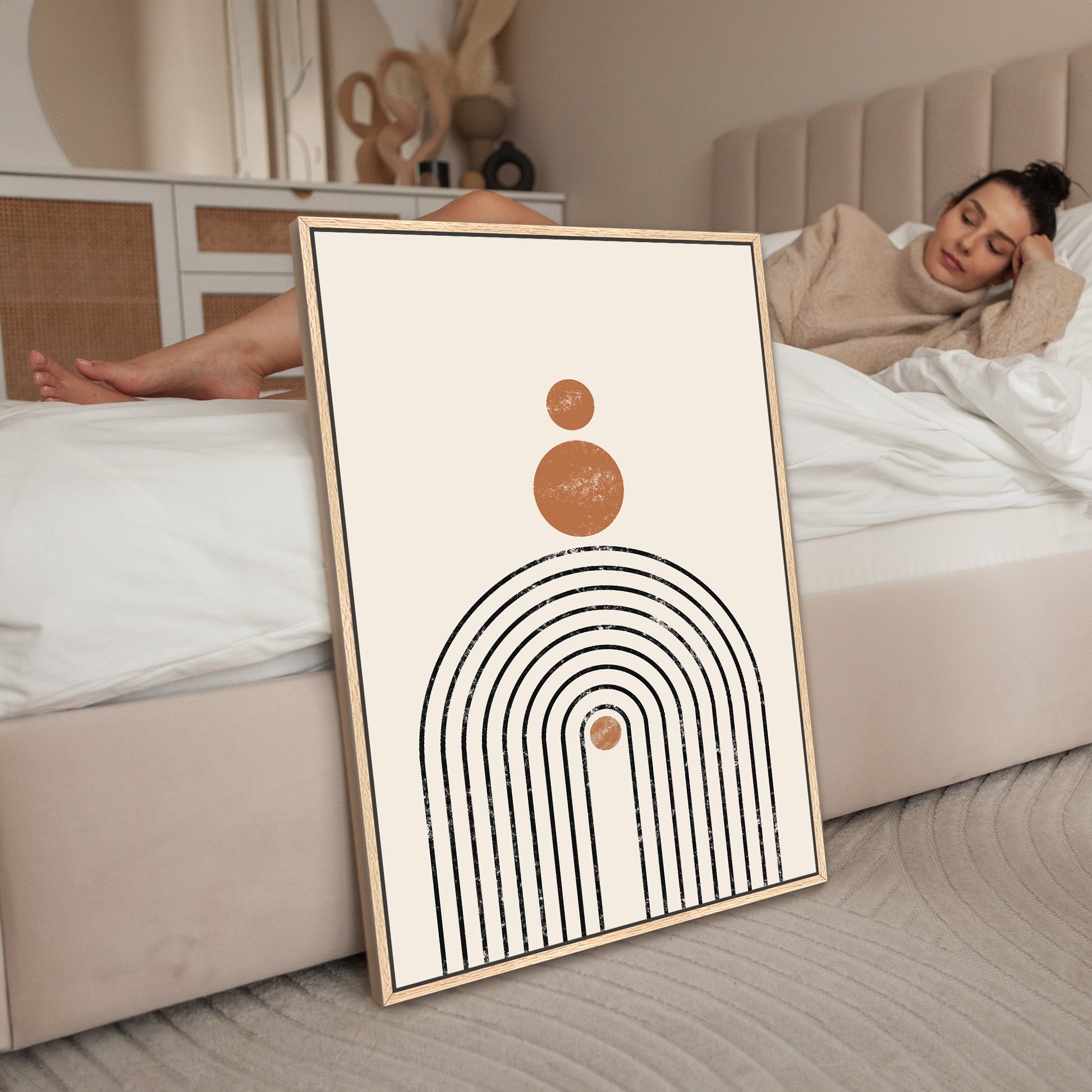 a woman laying on a bed next to a poster